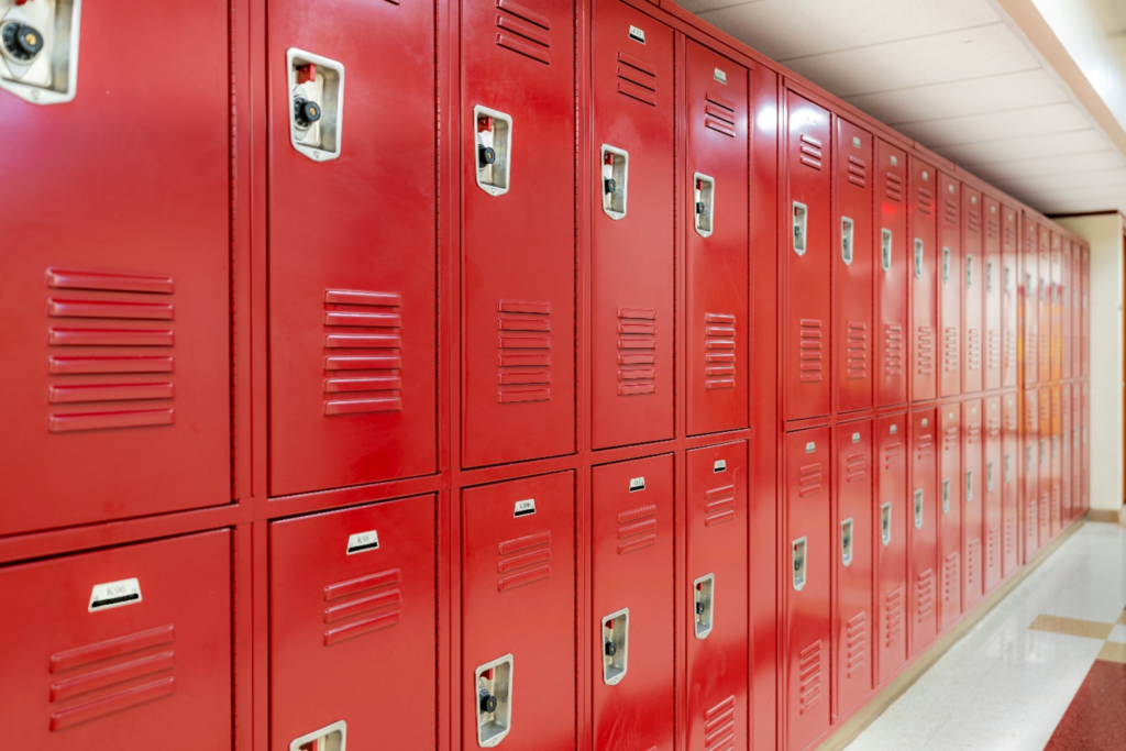 Row of red lockers in a school hallway.