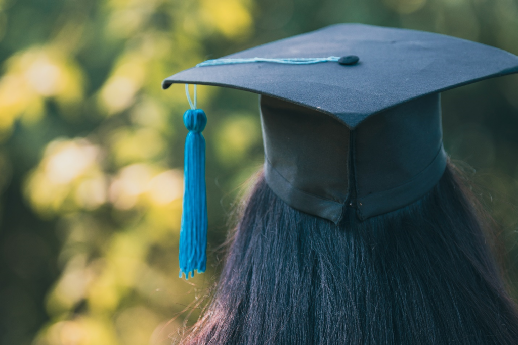 Back closeup of student wearing mortarboard.