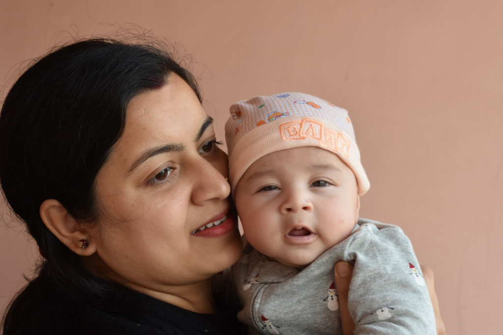 Mom holding cute baby.