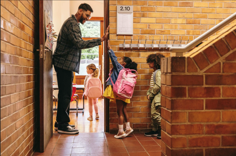 decorative, teacher welcoming young students to class